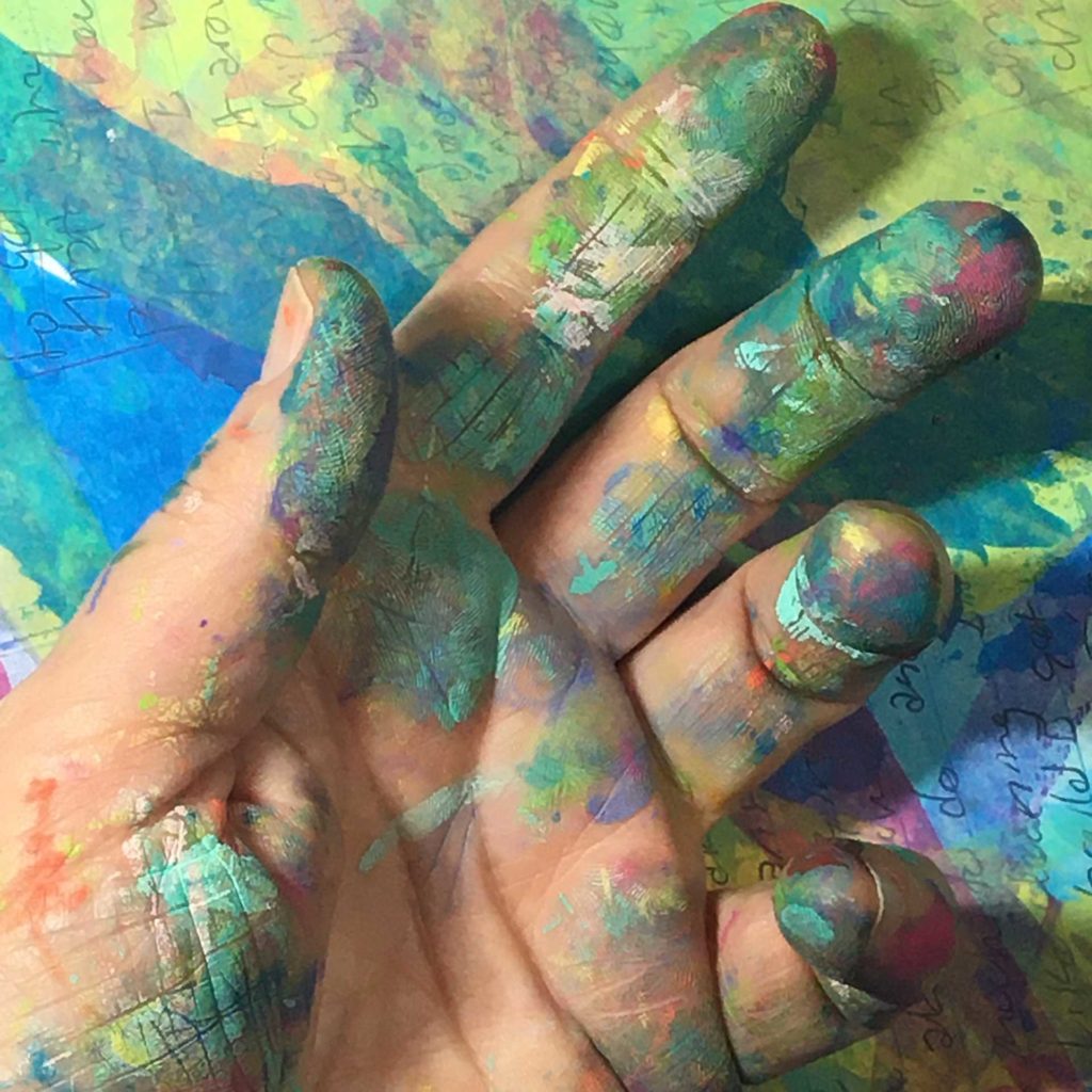 Fingers covered in colorful paint