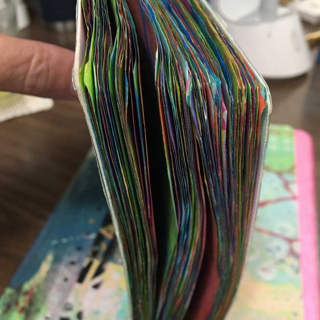 Painted pages of a composition notebook