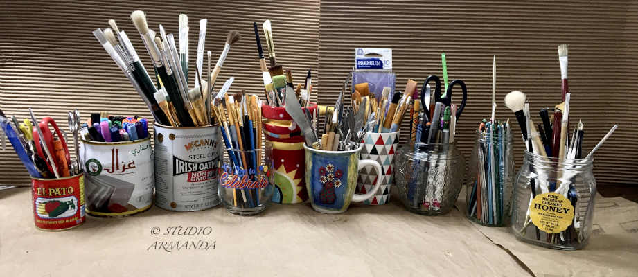 A row of bottles and cans repurposed into brush and tool holders